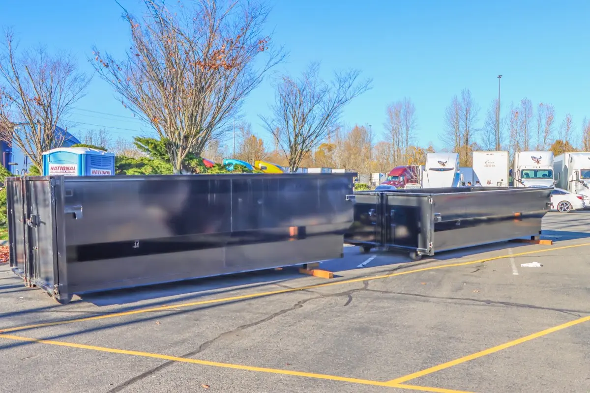 Professional dumpster rental service with roll-off container on residential driveway in Randallstown